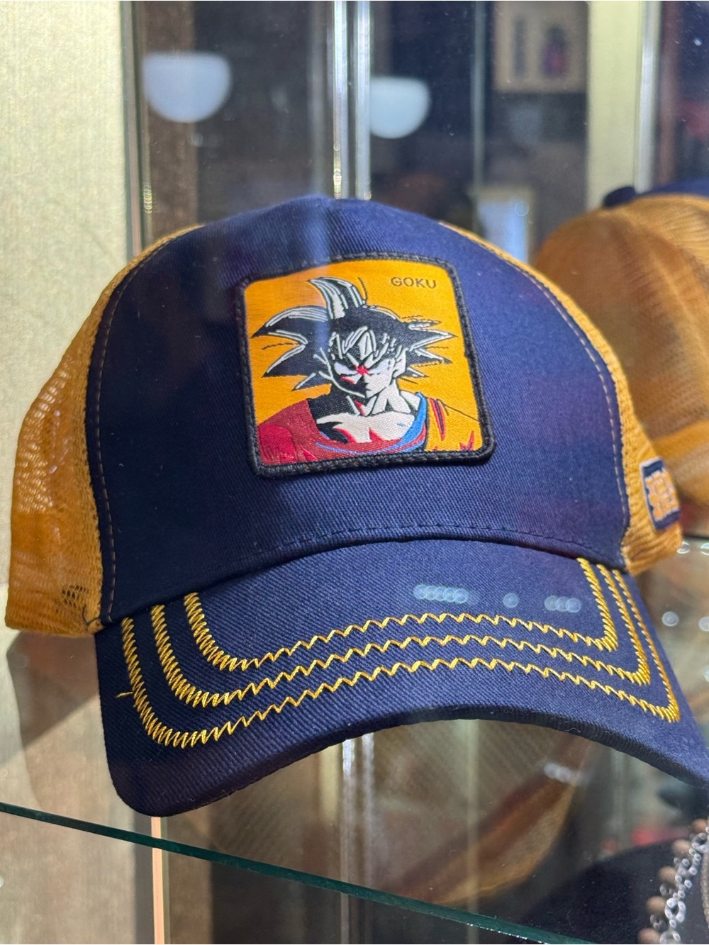Goku Patch Trucker Hat in Navy & Mustard
